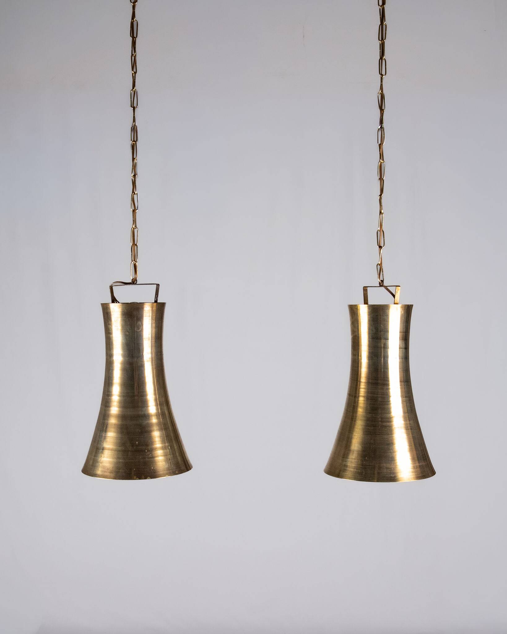 Pair of brass pendants, hourglass shape, 1960s