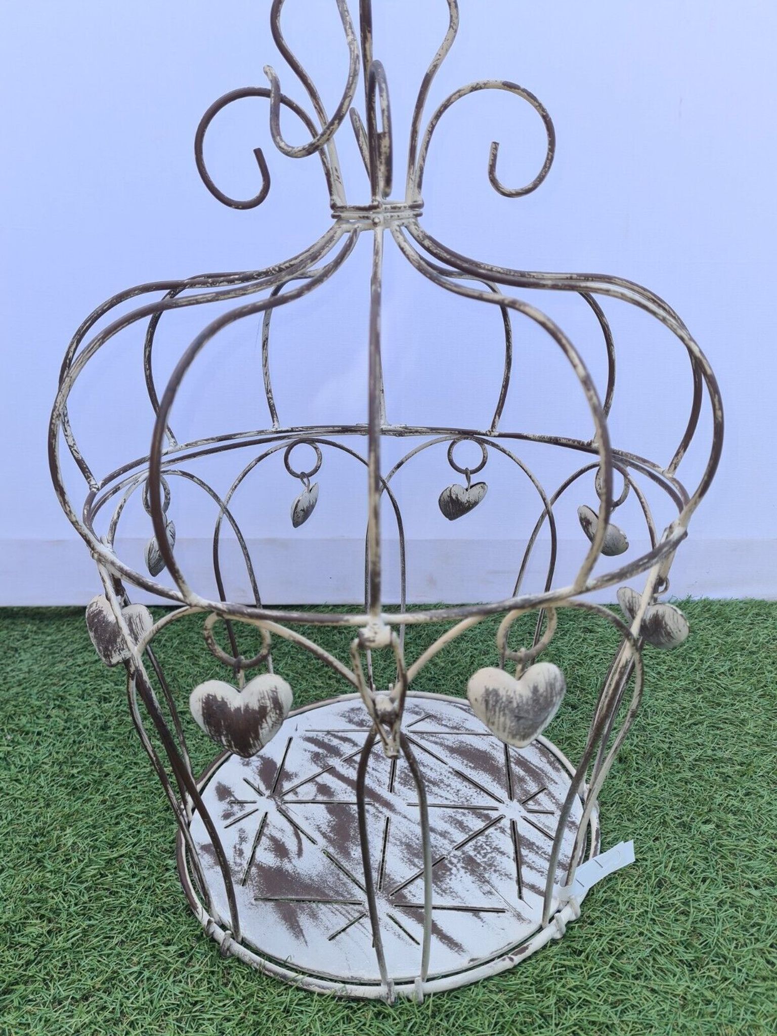 Decorative bird cage with iron hearts
