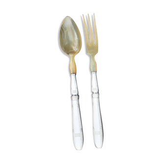 Corn and silver metal salad cutlery