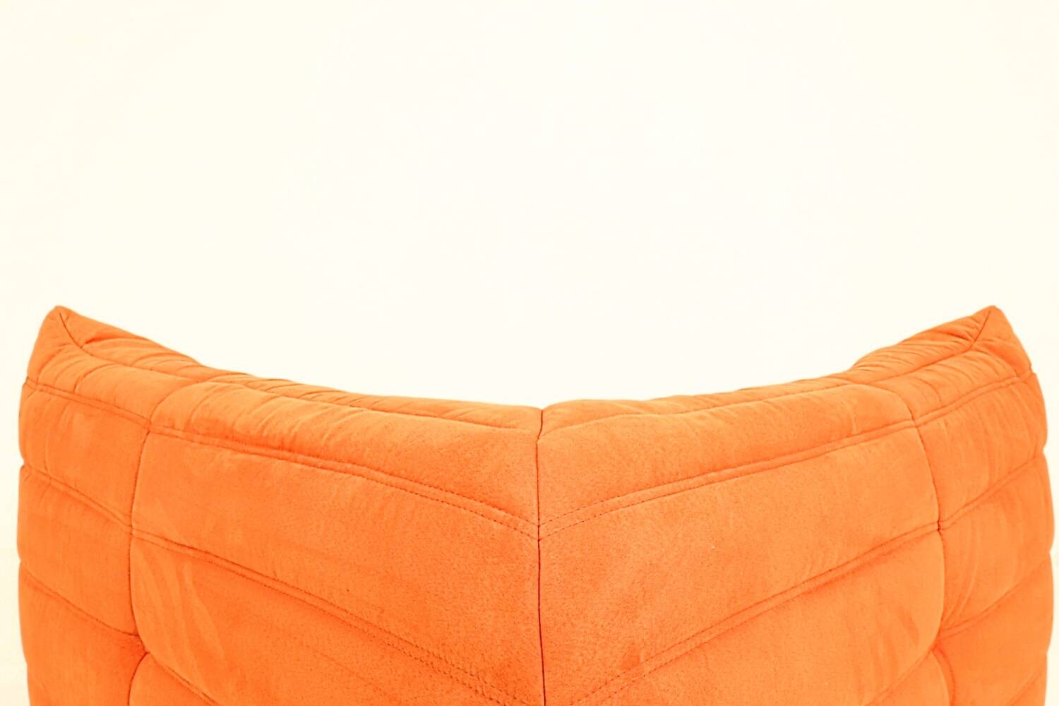 Togo sofa set and armchairs in pumpkin orange, 3 pieces, no label.