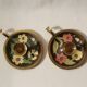 Set of 2 round golden metal candle holders and floral patterns