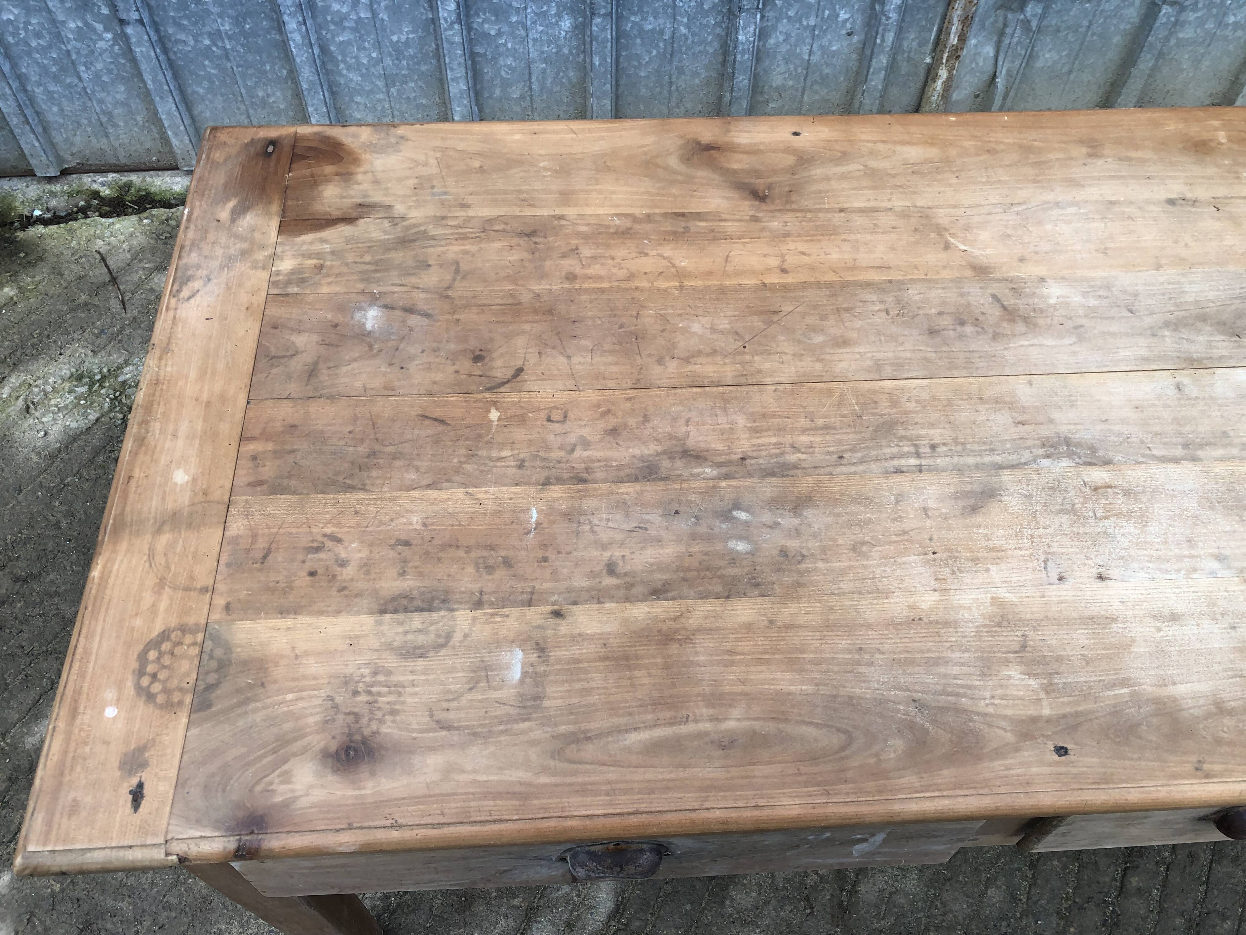 Antique solid cherry farm table with 3 front drawers.