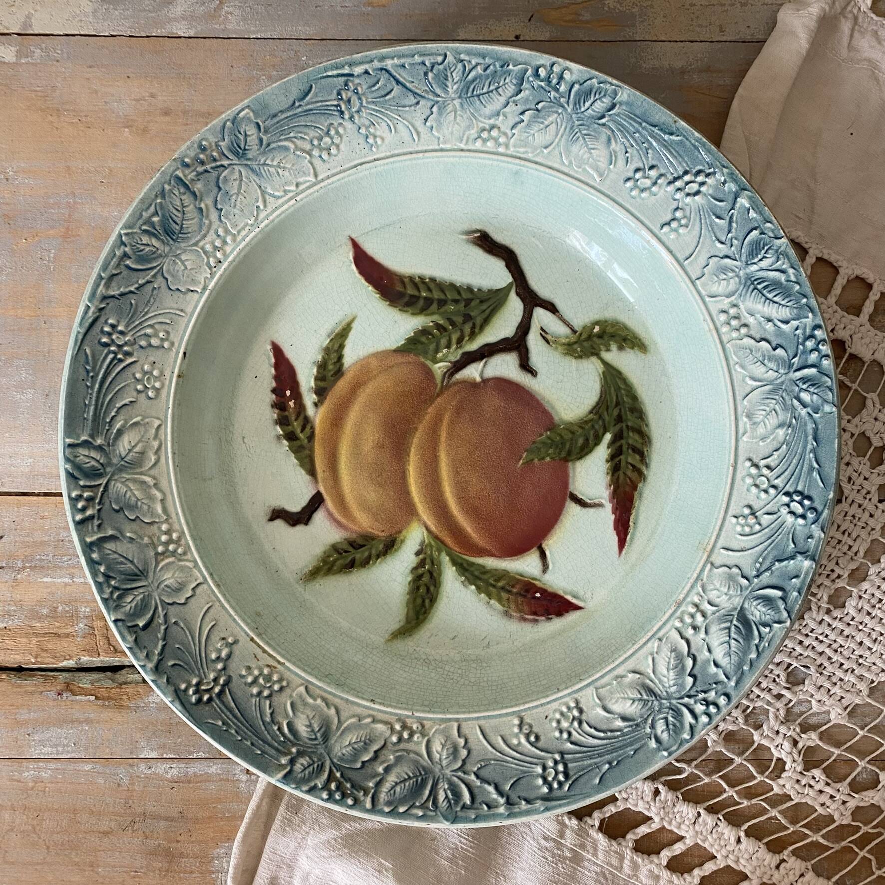 Shallow dish in slip with fruit decoration of peaches.