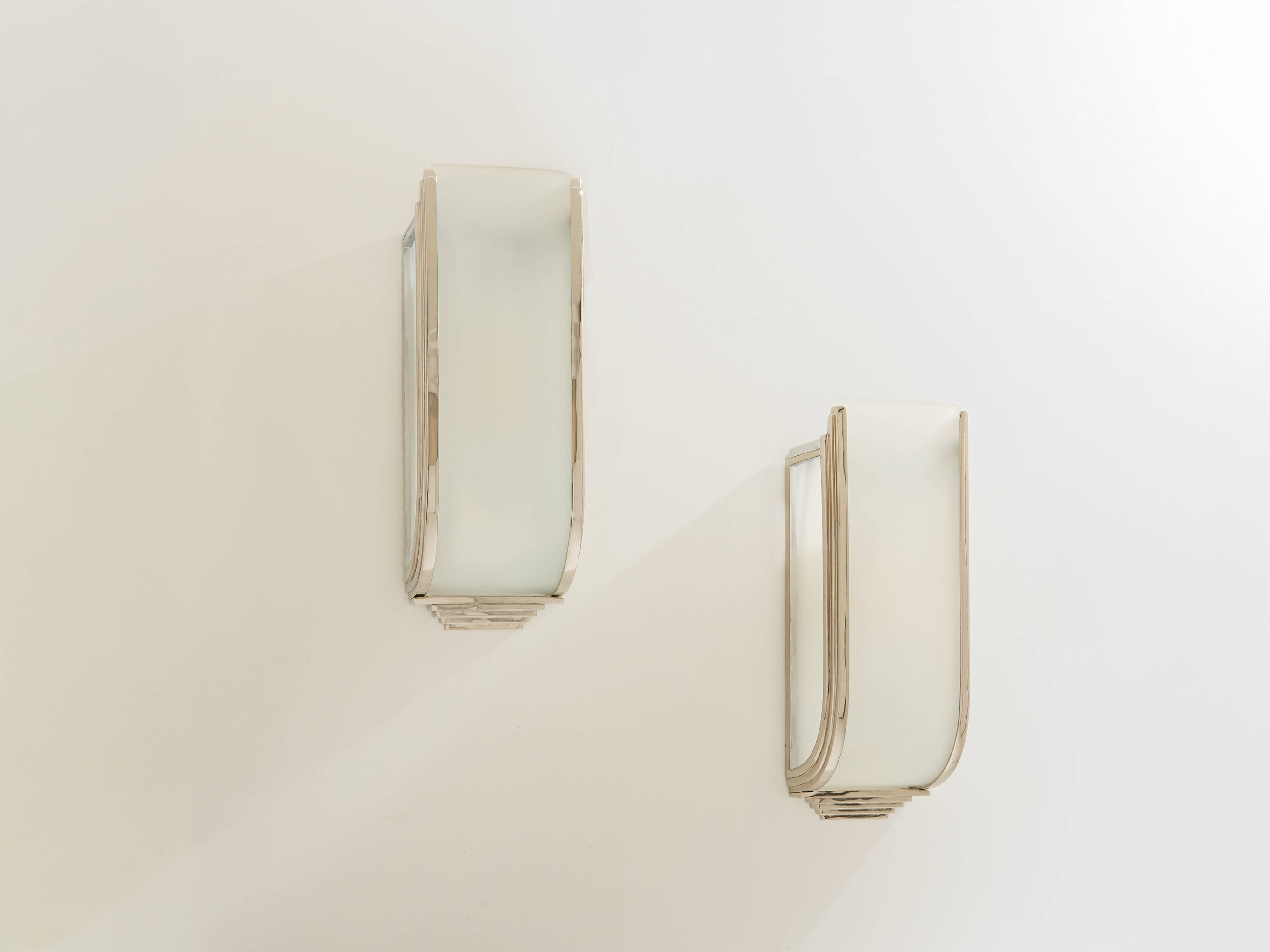 Pair of modernist wall sconces in nickel-plated steel and opaline glass, 1930.