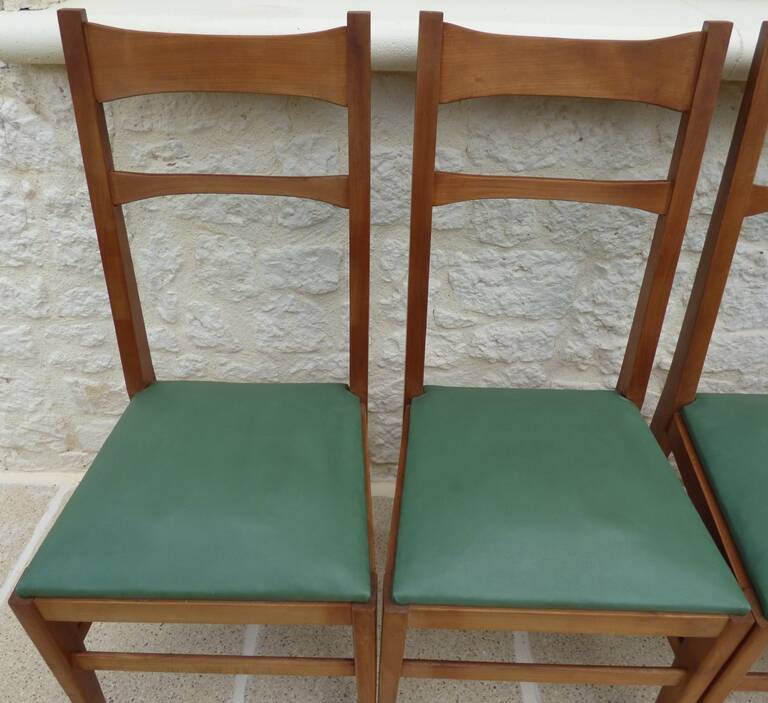 6 modern chairs with banded backs and green faux leather seats