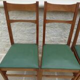 6 modern chairs with banded backs and green faux leather seats