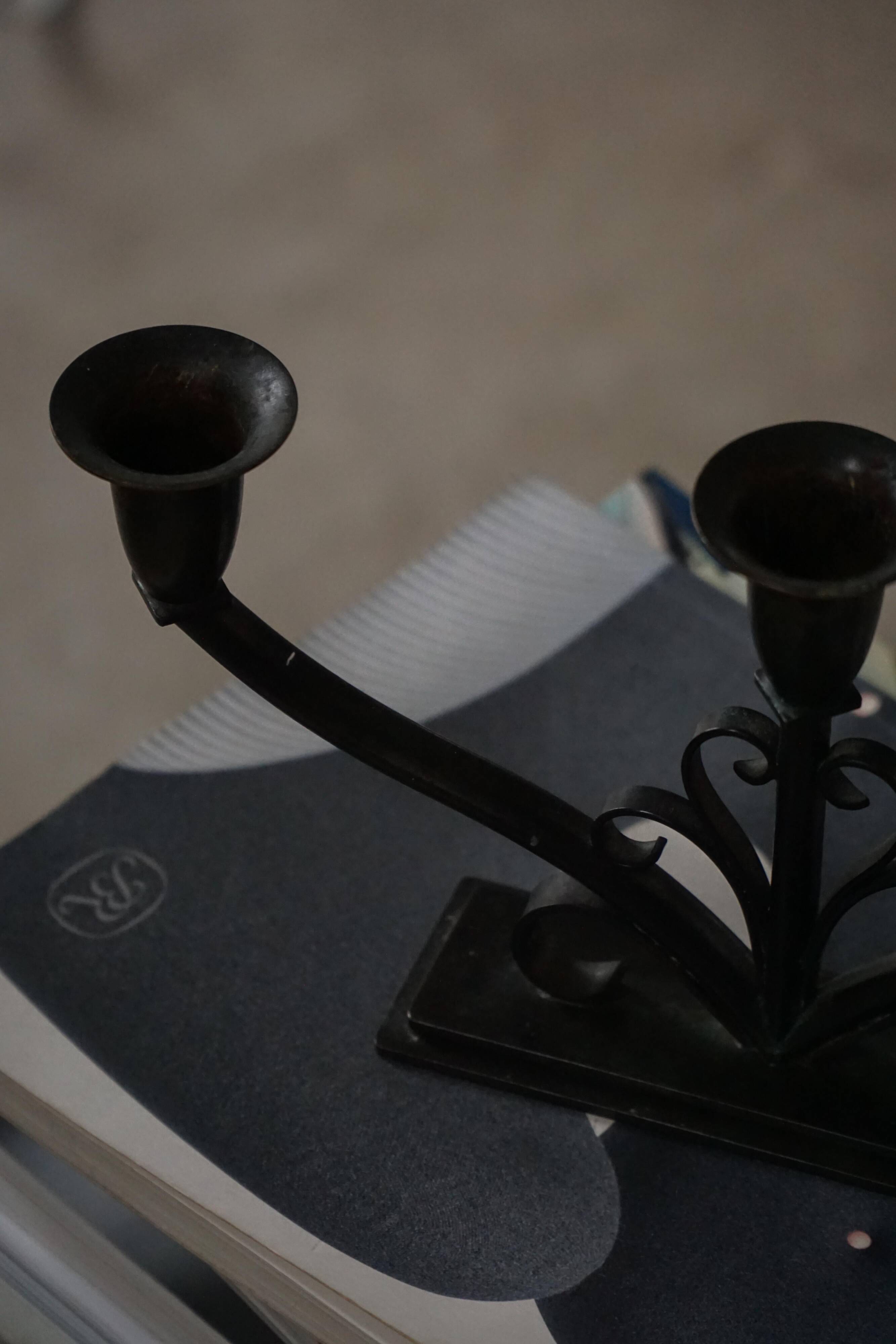 Early 20th century, pair of Danish Art Deco candlesticks in metal with three arms, 1930s.