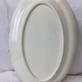 Old ivory-colored, oval-shaped dish with chamfered edge
