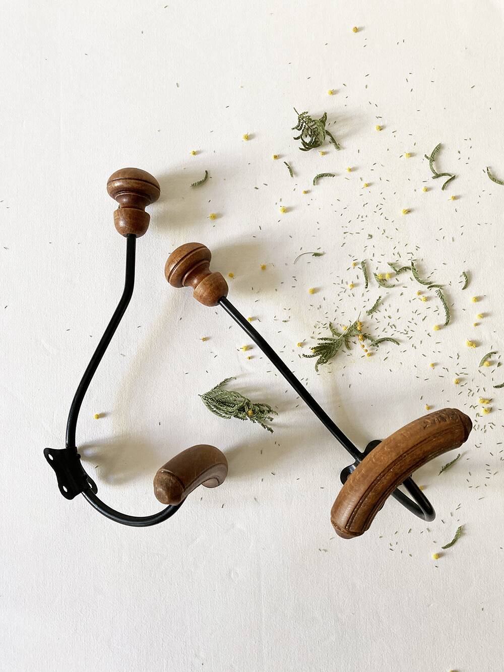 Pair of antique wooden and metal coat hooks