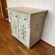 Antique low polychrome sideboard with floral decoration.