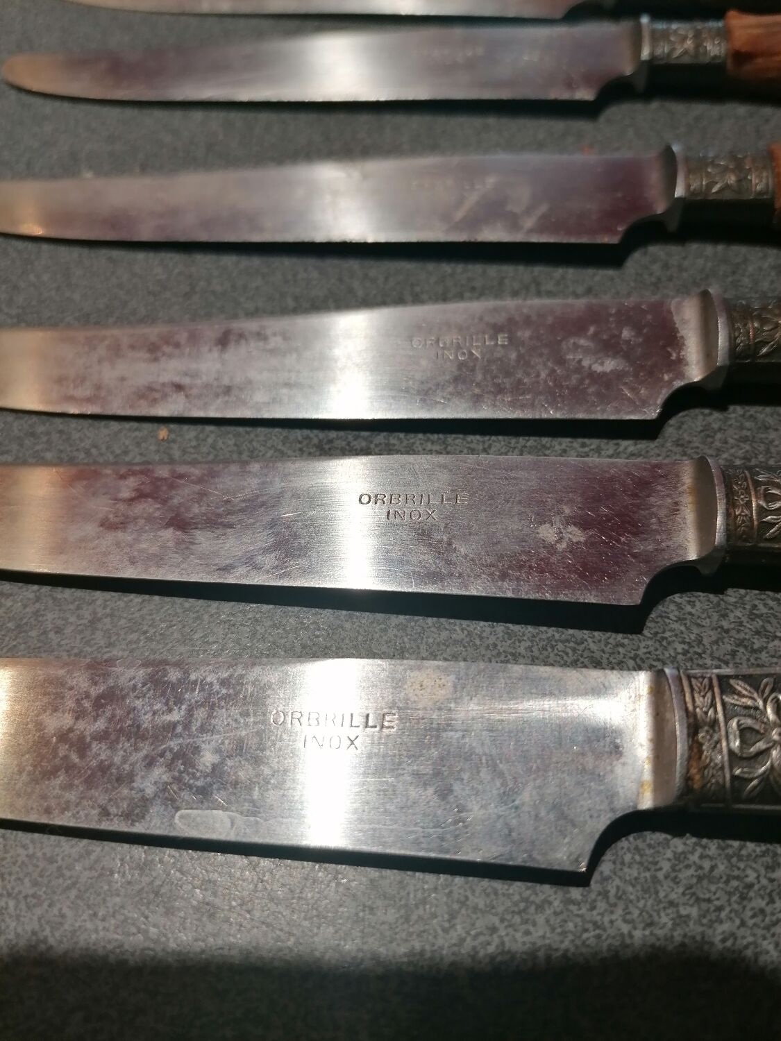 Old table knives and dessert knives, wooden handles, stainless steel blades