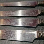 Old table knives and dessert knives, wooden handles, stainless steel blades