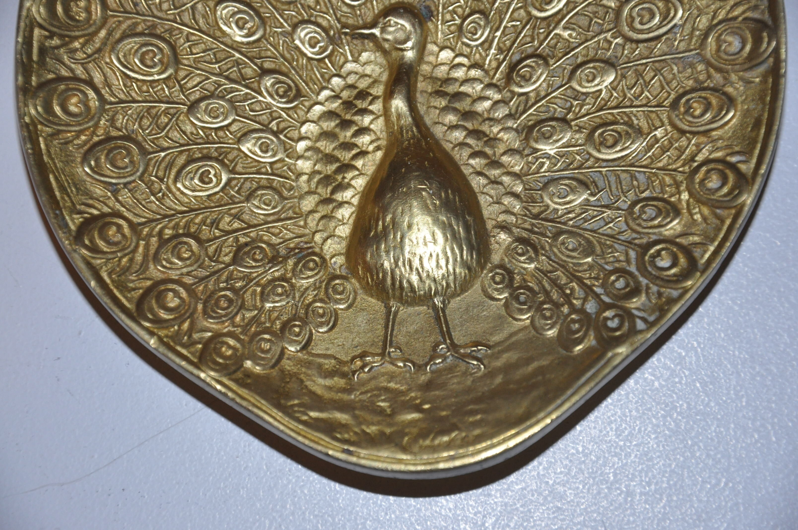 Brass pocket with peacock decoration