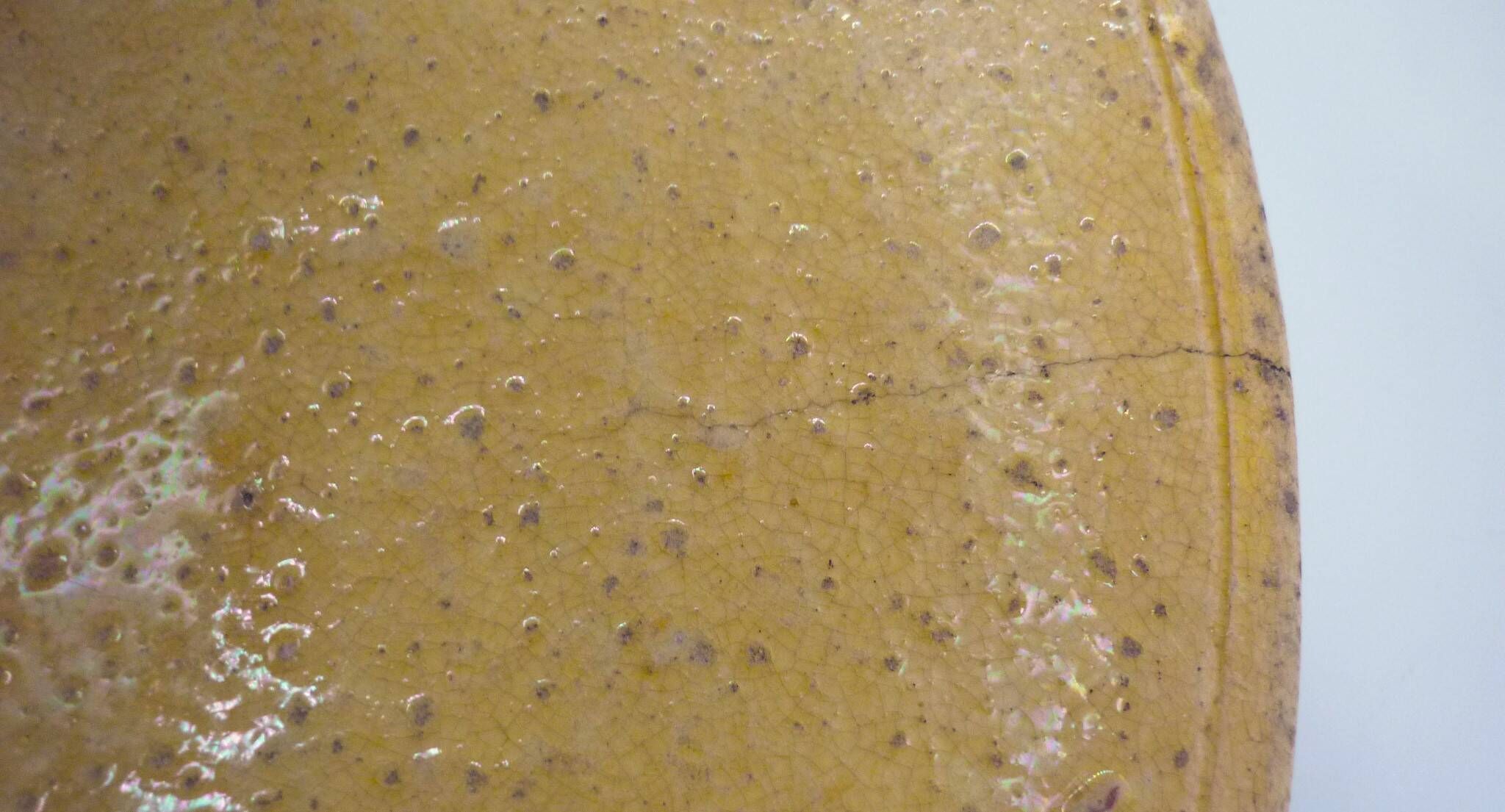 Old omelette turner, glazed yellow terracotta, south of France.