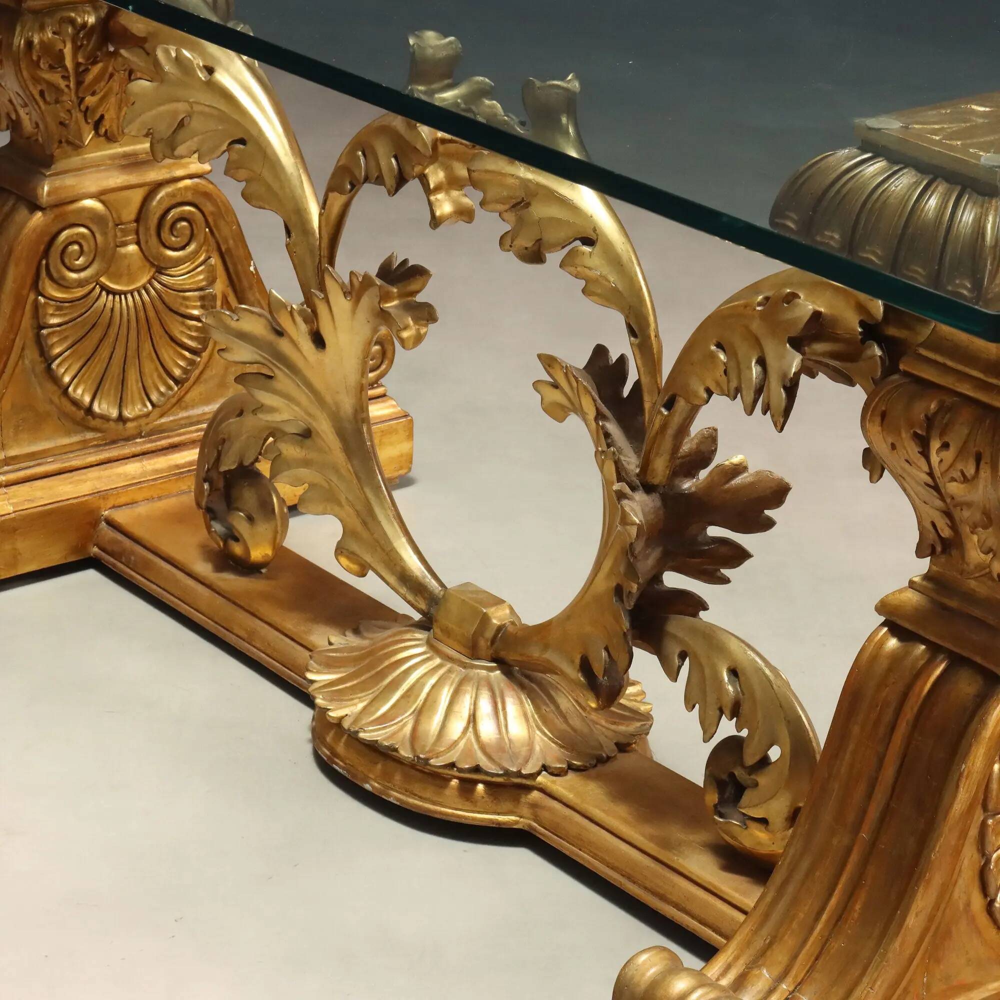 Antique coffee table in gilded wood with a glass top, Italy, 20th century.
