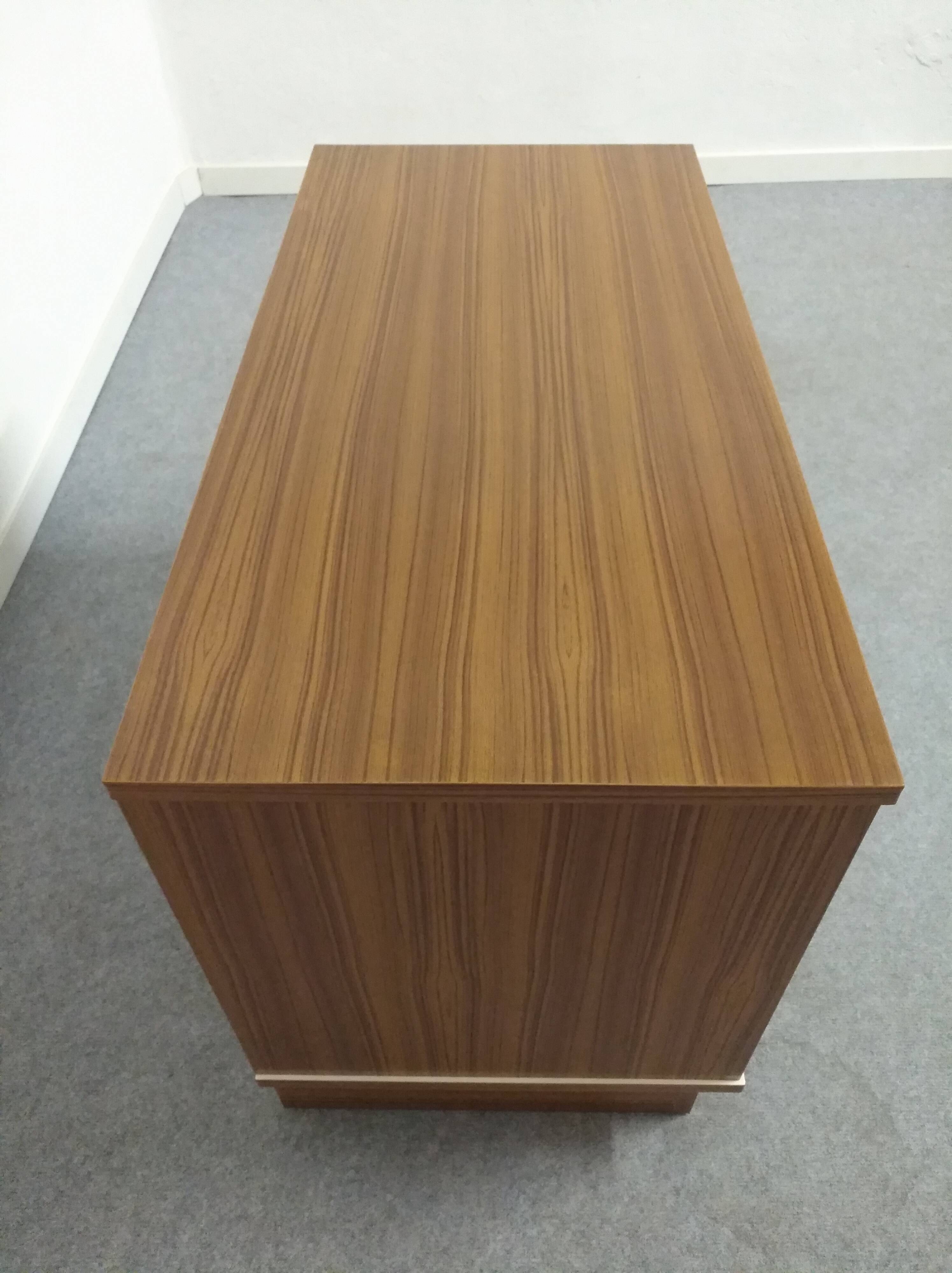 Low chest of drawers with 3 drawers in mahogany and white satin, France circa 1980.