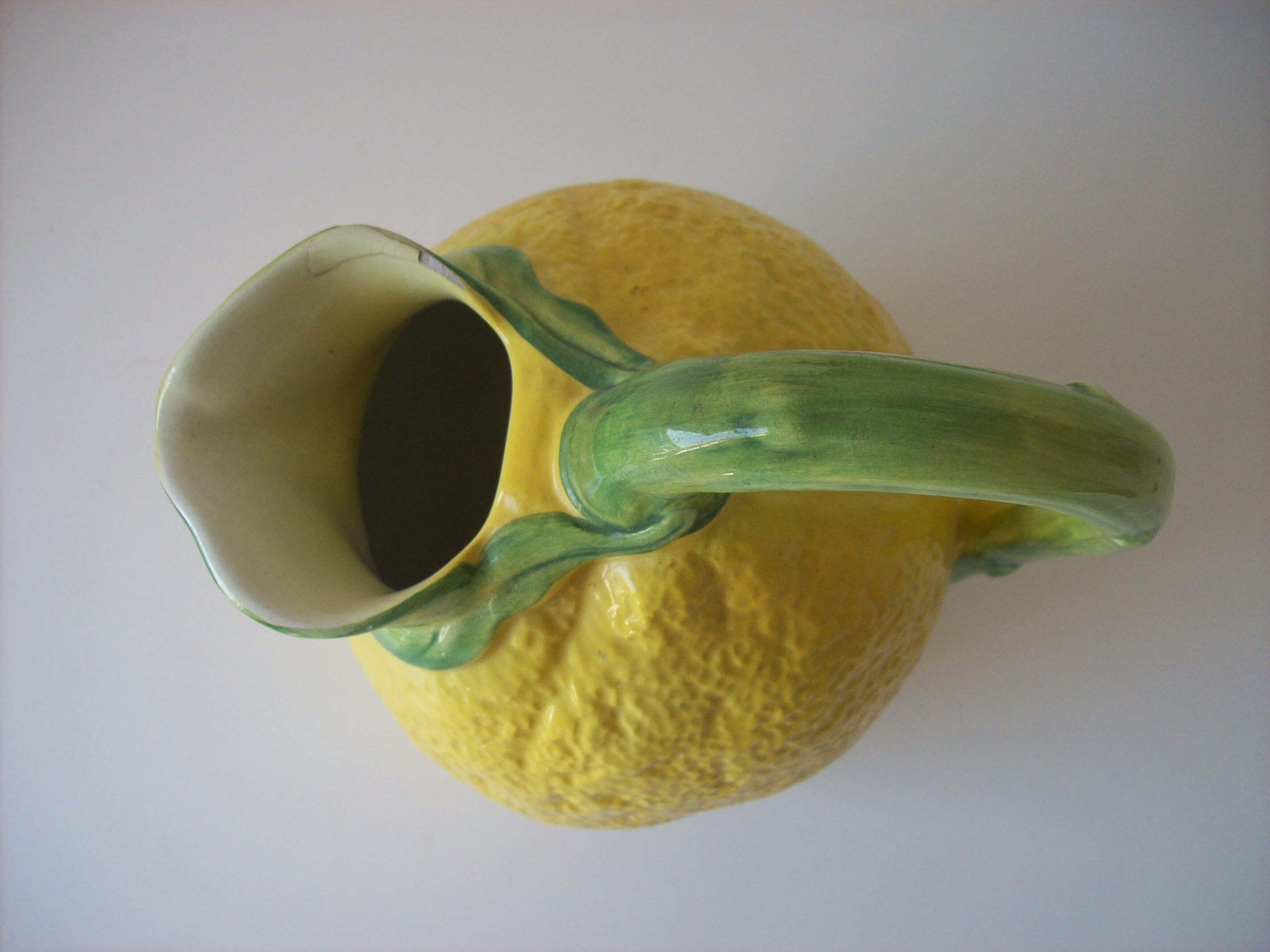 Vintage pitcher has form of lemon