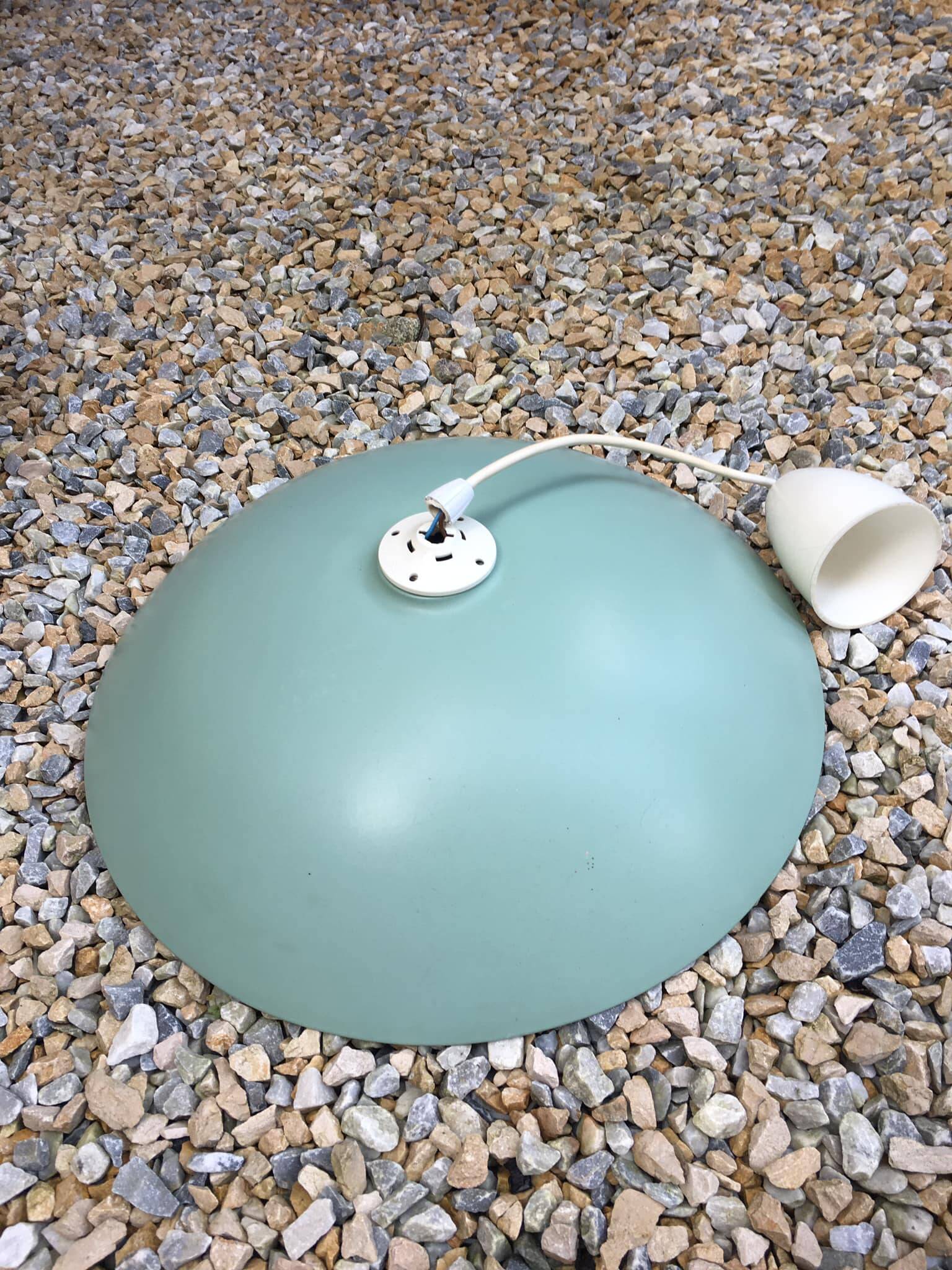 Pastel green metal pendant light. White cord.