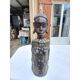 African statue of a woman, made of wood, brass, beads, and seashells.