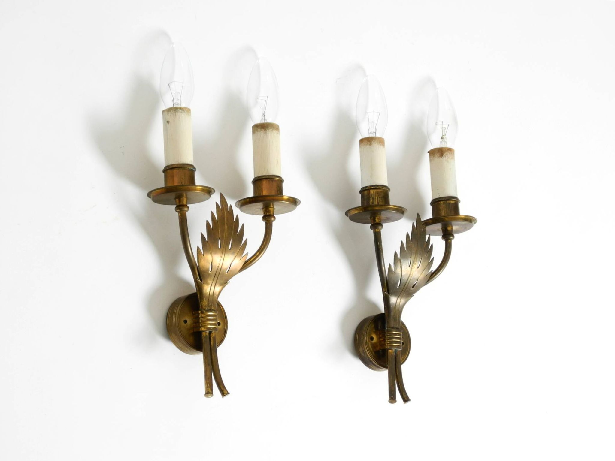 A pair of mid-century modern brass wall lamps by Vereinigte Werkstätten