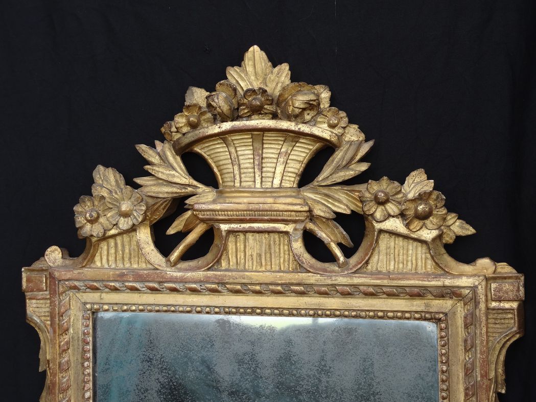 Louis XVI period mirror in gilded carved wood