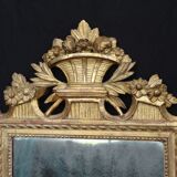 Louis XVI period mirror in gilded carved wood