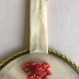 Old medallion frame of dried flowers of oval shape. To hang with velvet stripe.