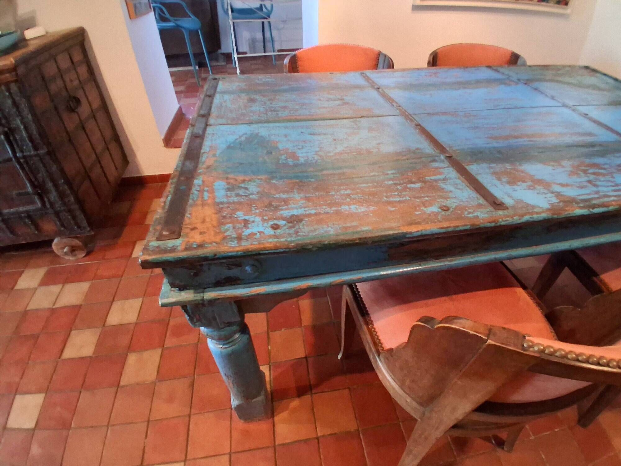 Large antique Indian dining table made of teak wood with patina.
