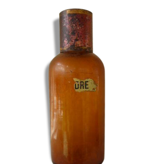 Old bottle of pharmacy, ochre-colored glass, metal, red patina Cap