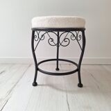 Black iron stool/pouf with its boucle fabric cushion.