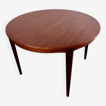 Round teak table with Scandinavian design extensions from the 60s vintage