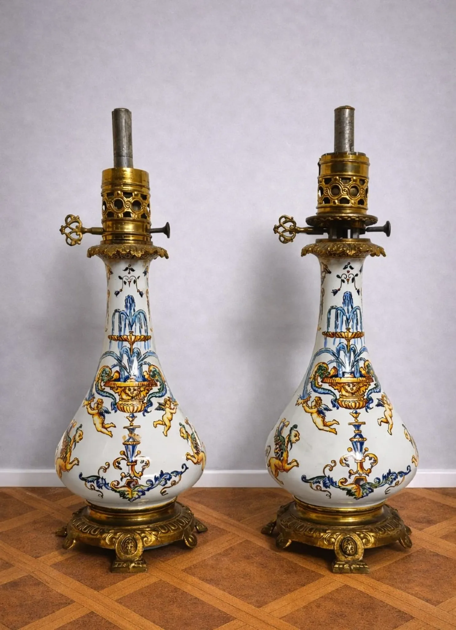 Gien: pair of antique oil lamps in fine earthenware richly decorated.