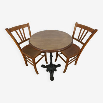 oak tray table with cast iron legs and pair of bistro chairs