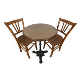 oak tray table with cast iron legs and pair of bistro chairs