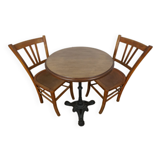 oak tray table with cast iron legs and pair of bistro chairs