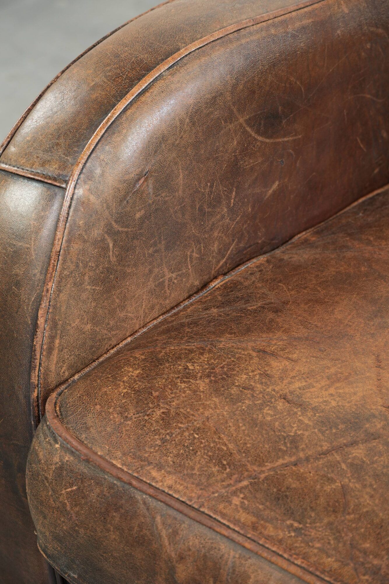 Comfortable sheepskin armchair with matching piping and a timeless look