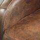 Comfortable sheepskin armchair with matching piping and a timeless look