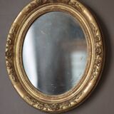 Oval wall mirror with gilded frame and mercury glass. Late 19th-early 20th century.