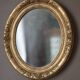 Oval wall mirror with gilded frame and mercury glass. Late 19th-early 20th century.