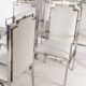 Suite de 6 fauteuils en inox et laiton