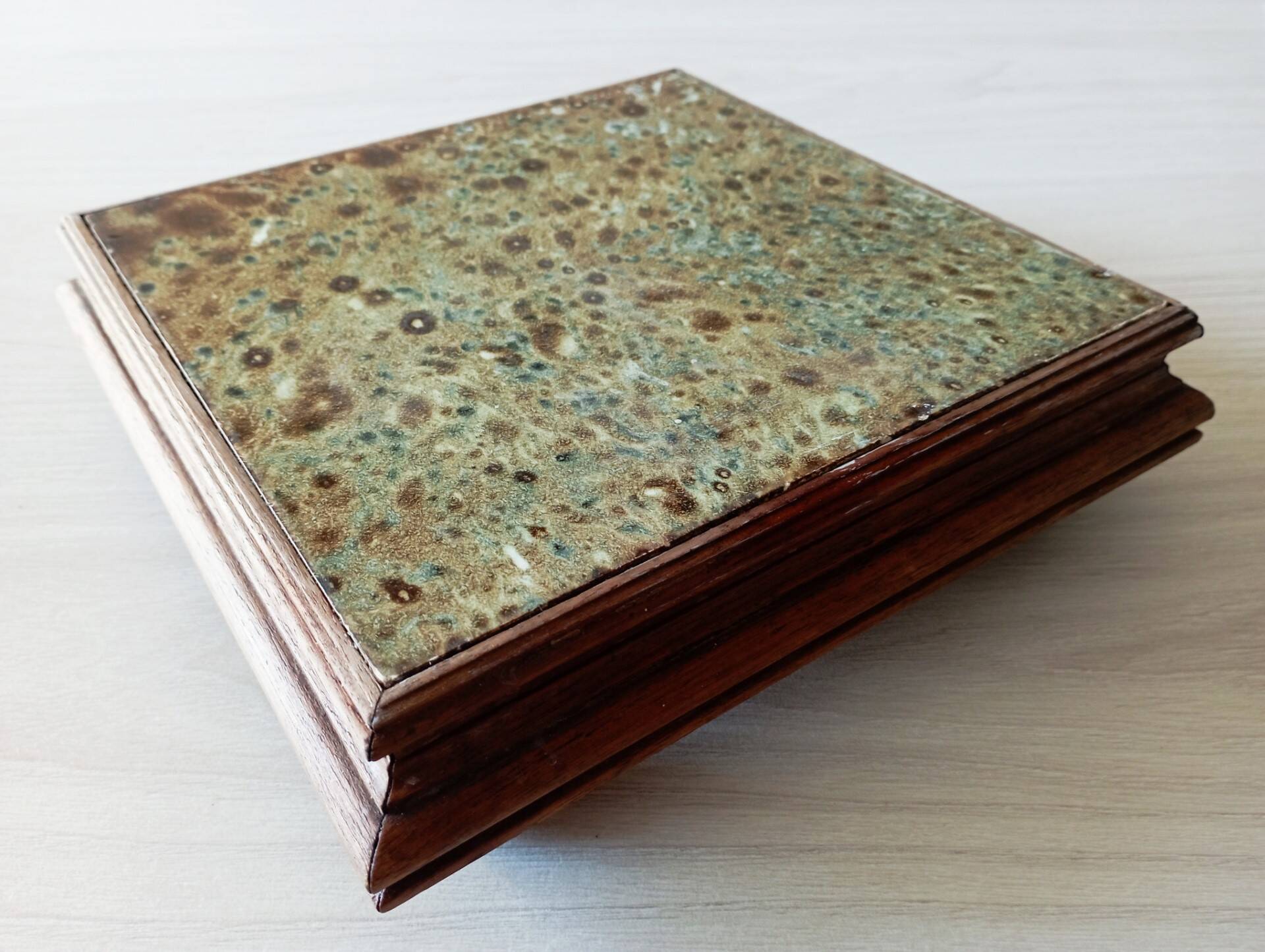 Old wood and ceramic trivet