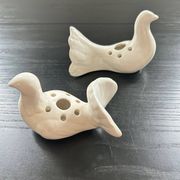 Duo of doves pecking flowers