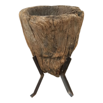Old wooden mortar on feet