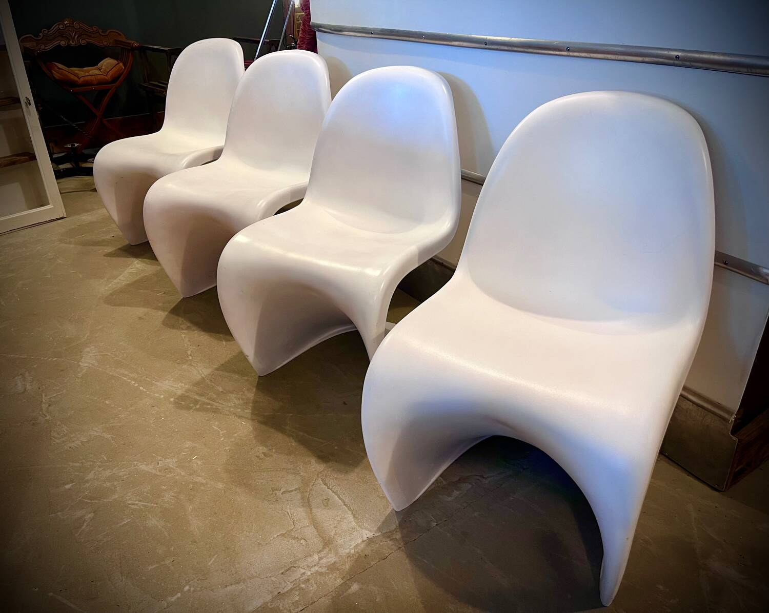 4 white Panton style armchairs