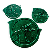 A trivet and two bottle holders in green Vallauris majolica.