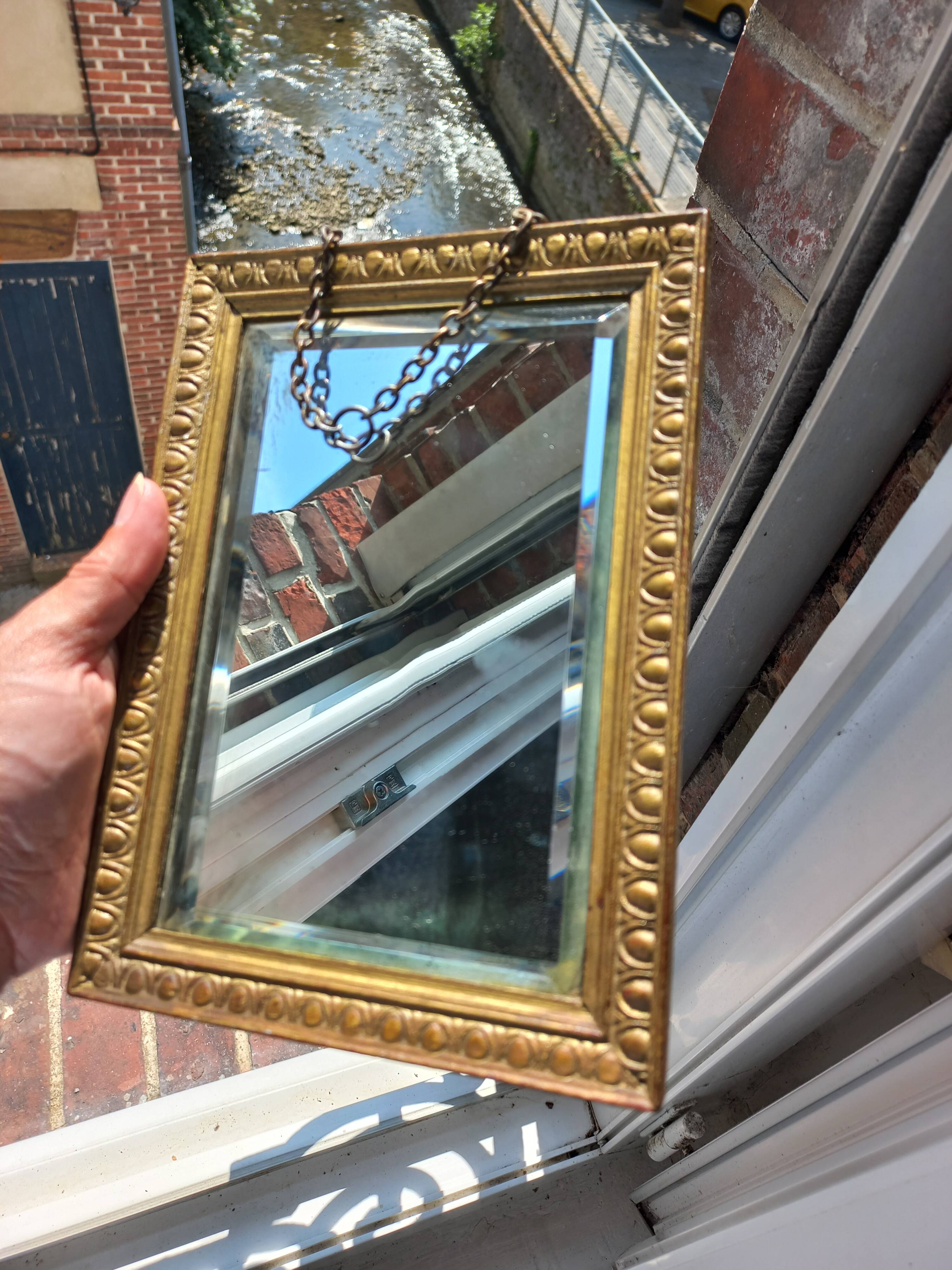 Small vintage mirror in gilded wood, bevelled glass with chain.