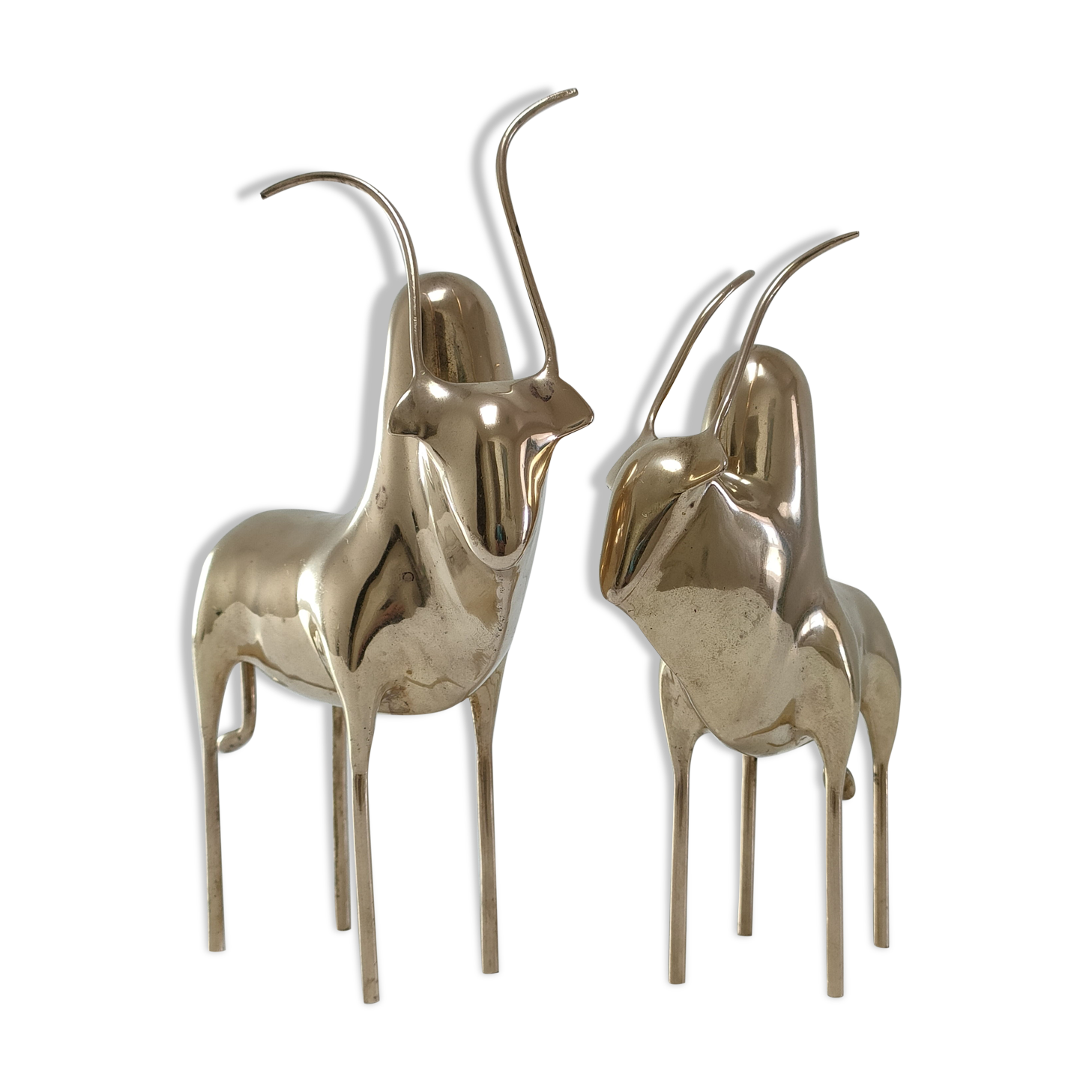 Two stylized zebu with long vintage brass horns