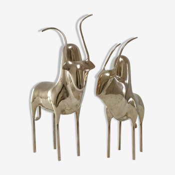 Two stylized zebu with long vintage brass horns