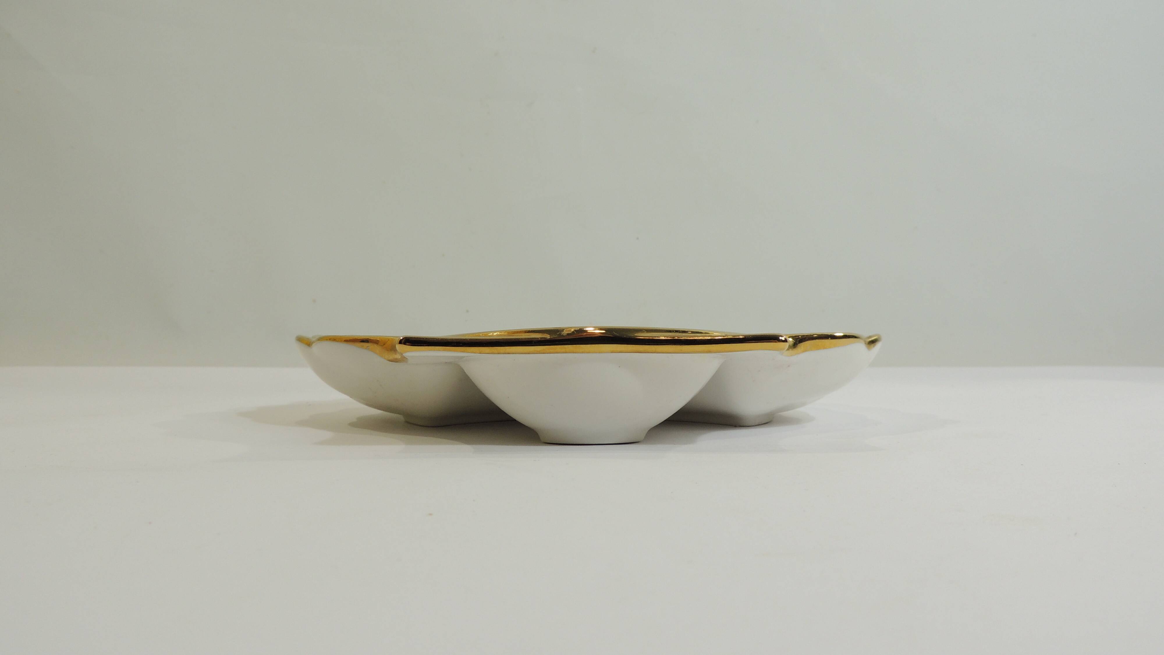 Shell-shaped porcelain pocket bowl from Queen’s Porcelain, with a gold rim.