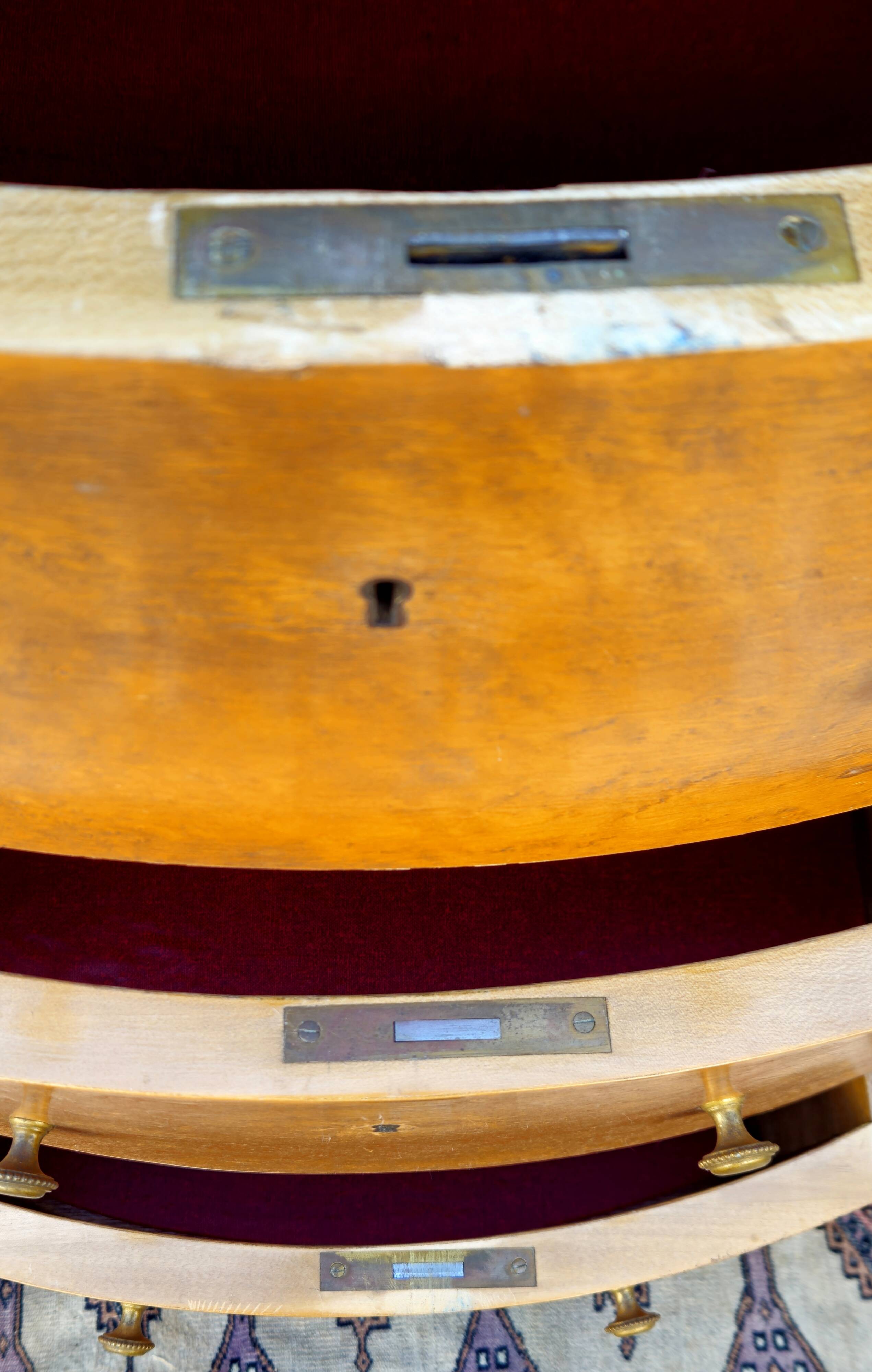 Half-moon commode in burl wood with a marble top.